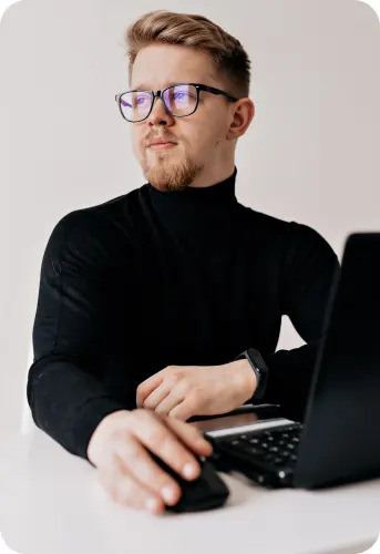 indoor-portrait-handsome-blond-man-working-laptop-white-modern-office
